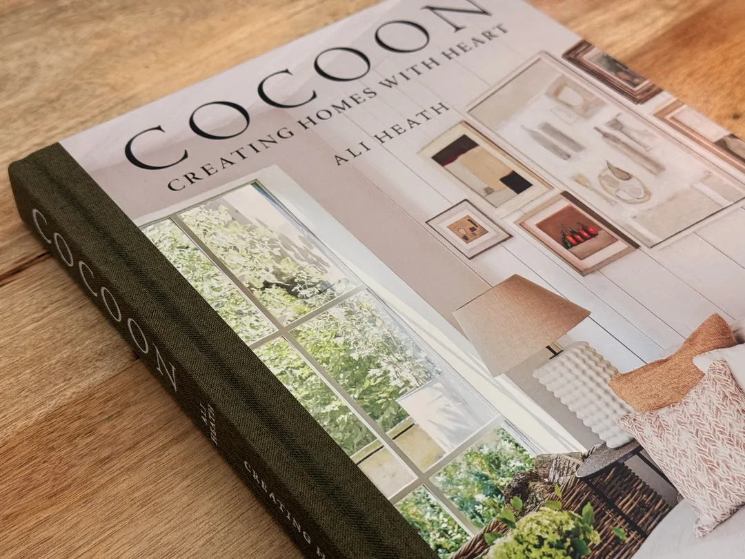 COCOON: Creating Homes with Heart by Ali Heath, hardcover on a wooden table