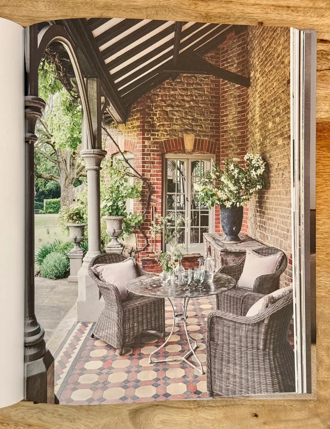 Victorian conservatory porch with wicker armchairs on encaustic tiles
