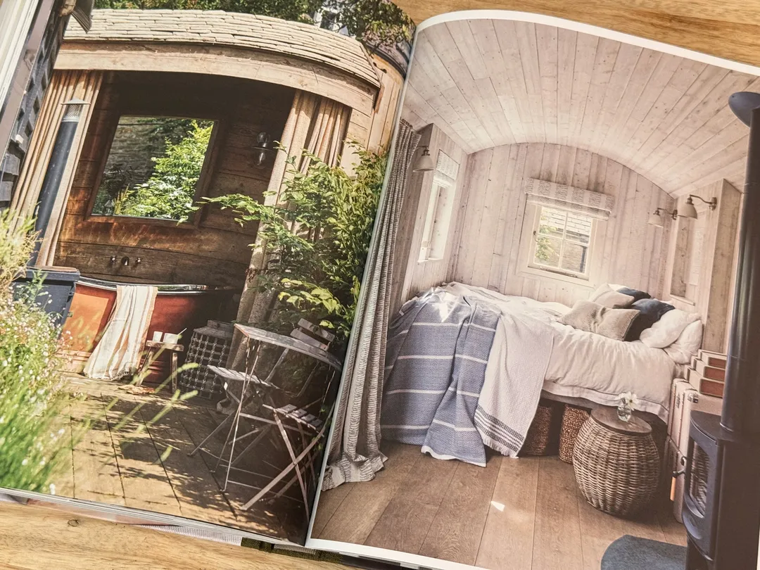 Shepherd's hut interior with a striped-blanket bed