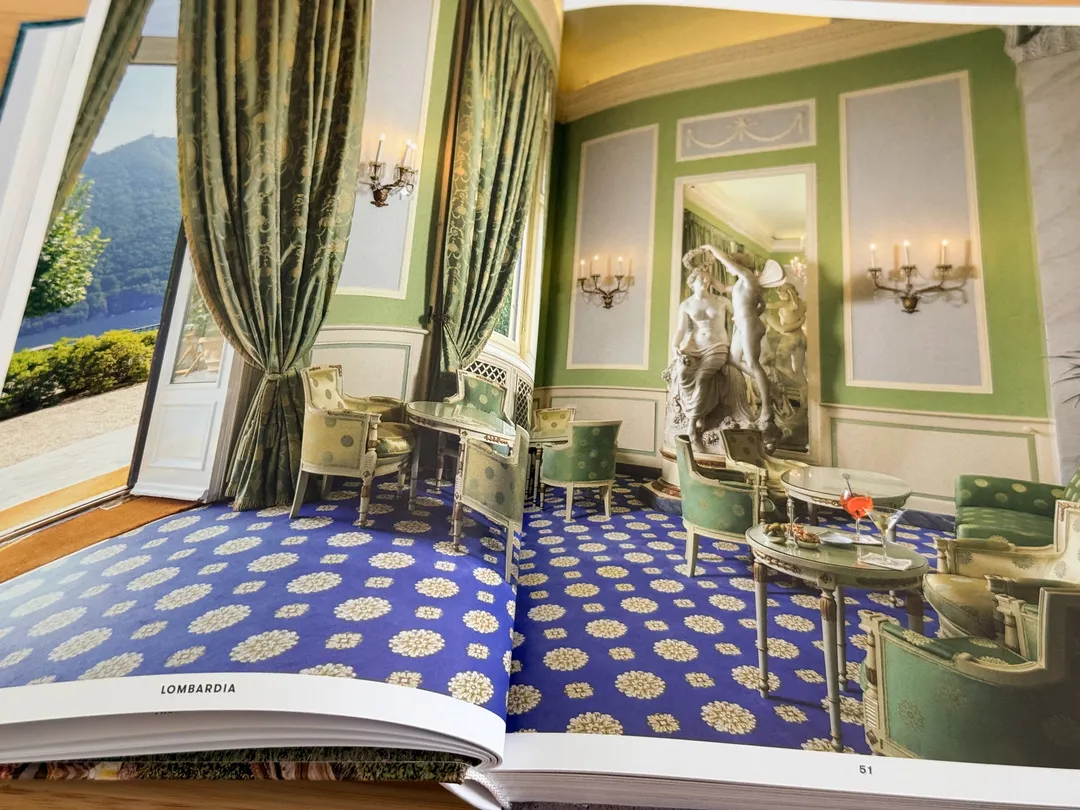 Opulent green salon with a blue-and-gold patterned carpet