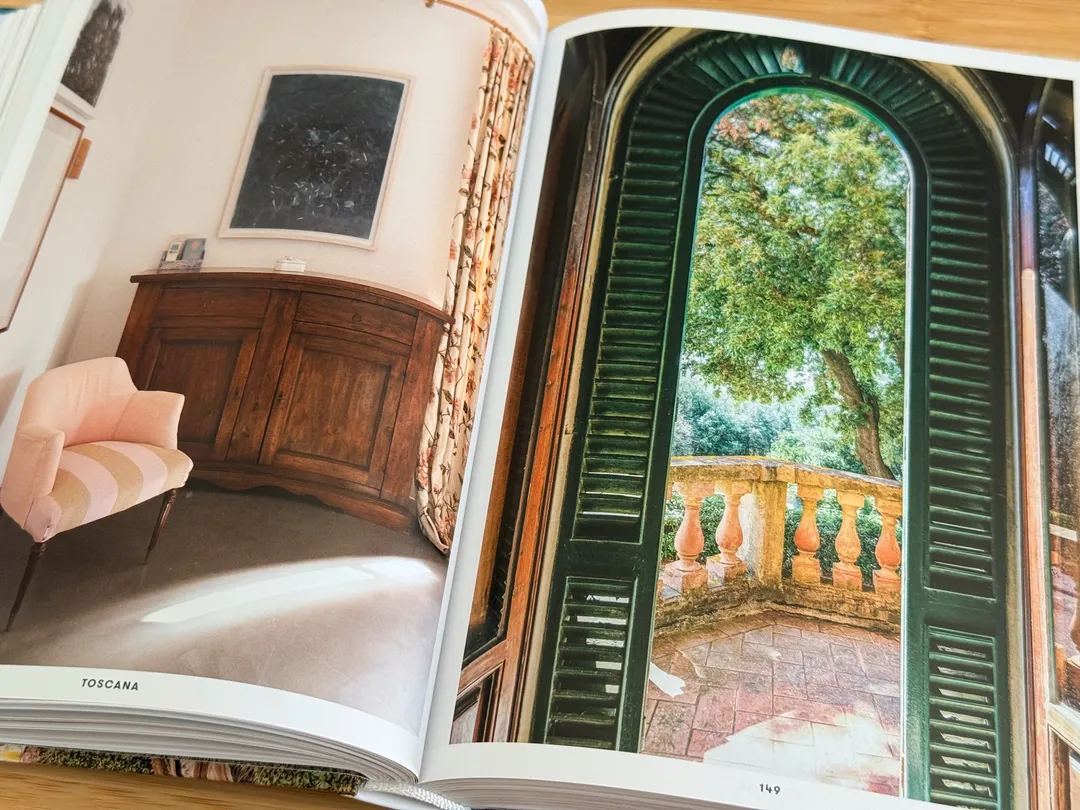 Hotel room with green shutters open onto a balustraded terrace