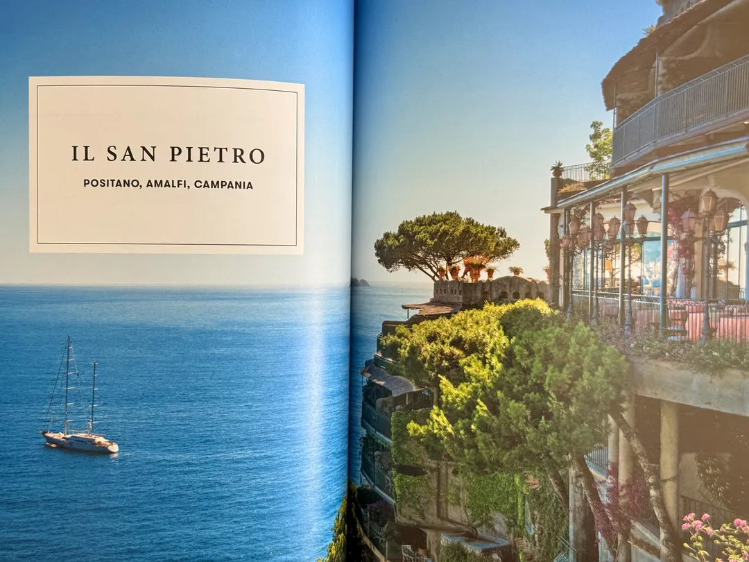 Il San Pietro in Positano: a sailboat on the open sea and a cliffside terrace