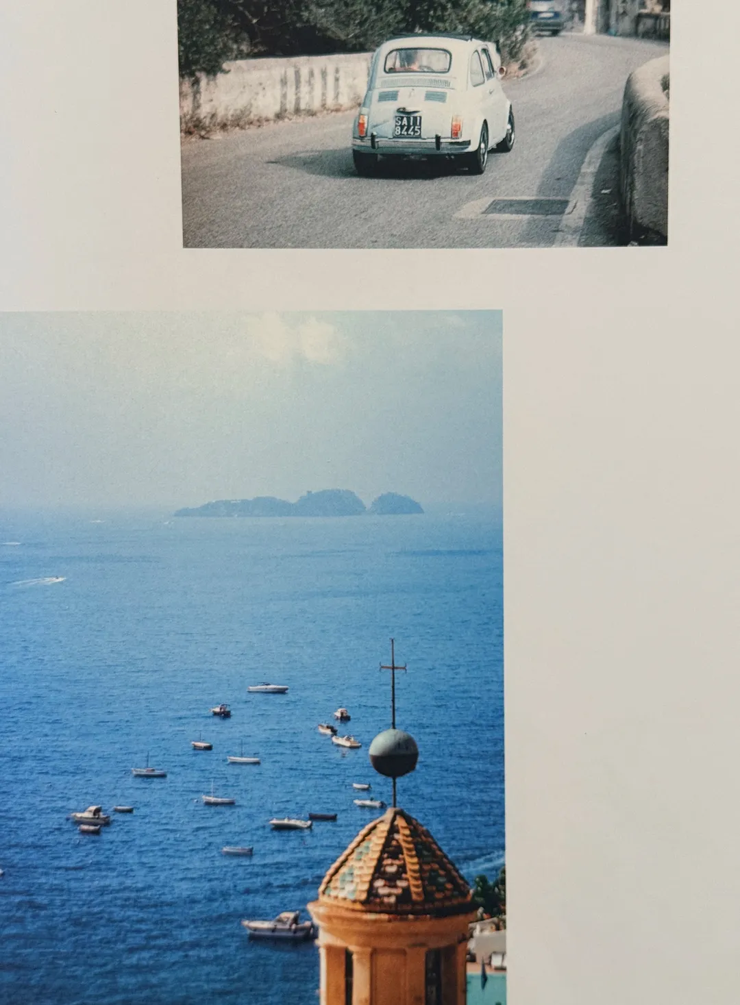 Vintage Fiat 500 on a coast road, and a bell tower above the bay of Positano