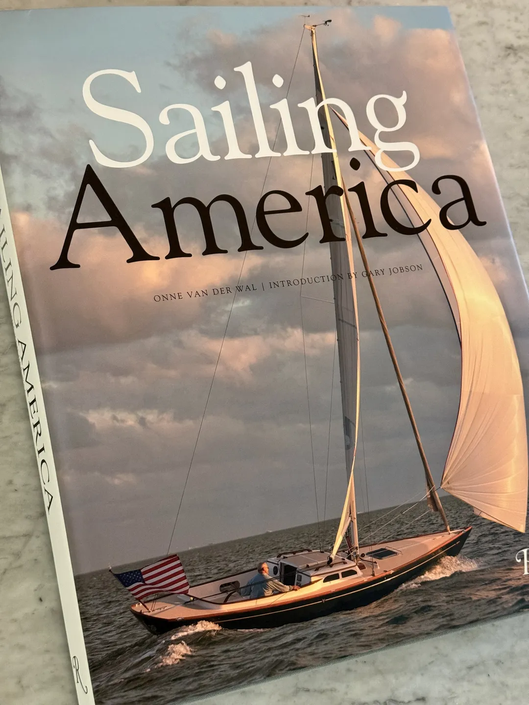 Sailing America by Onne van der Wal, cover of a classic wooden sloop under sail