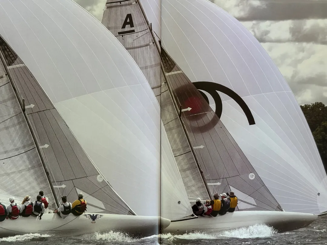 Two racing yachts side by side under white sails