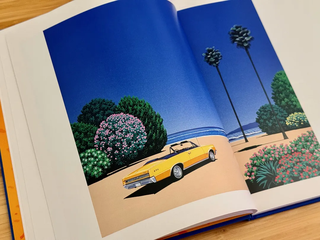Yellow convertible parked by flowering shrubs and palms