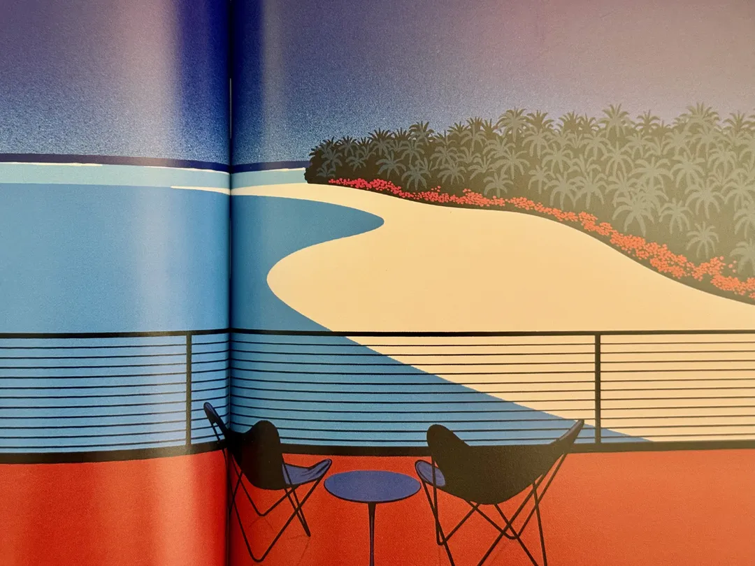 Balcony with butterfly chairs overlooking a curving sandy shore
