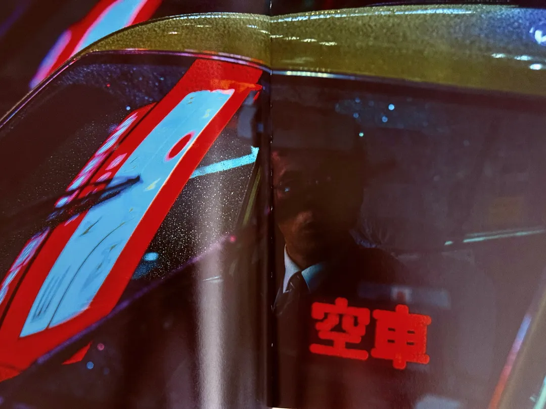 Close-up of a taxi with its red vacancy sign lit in Japanese