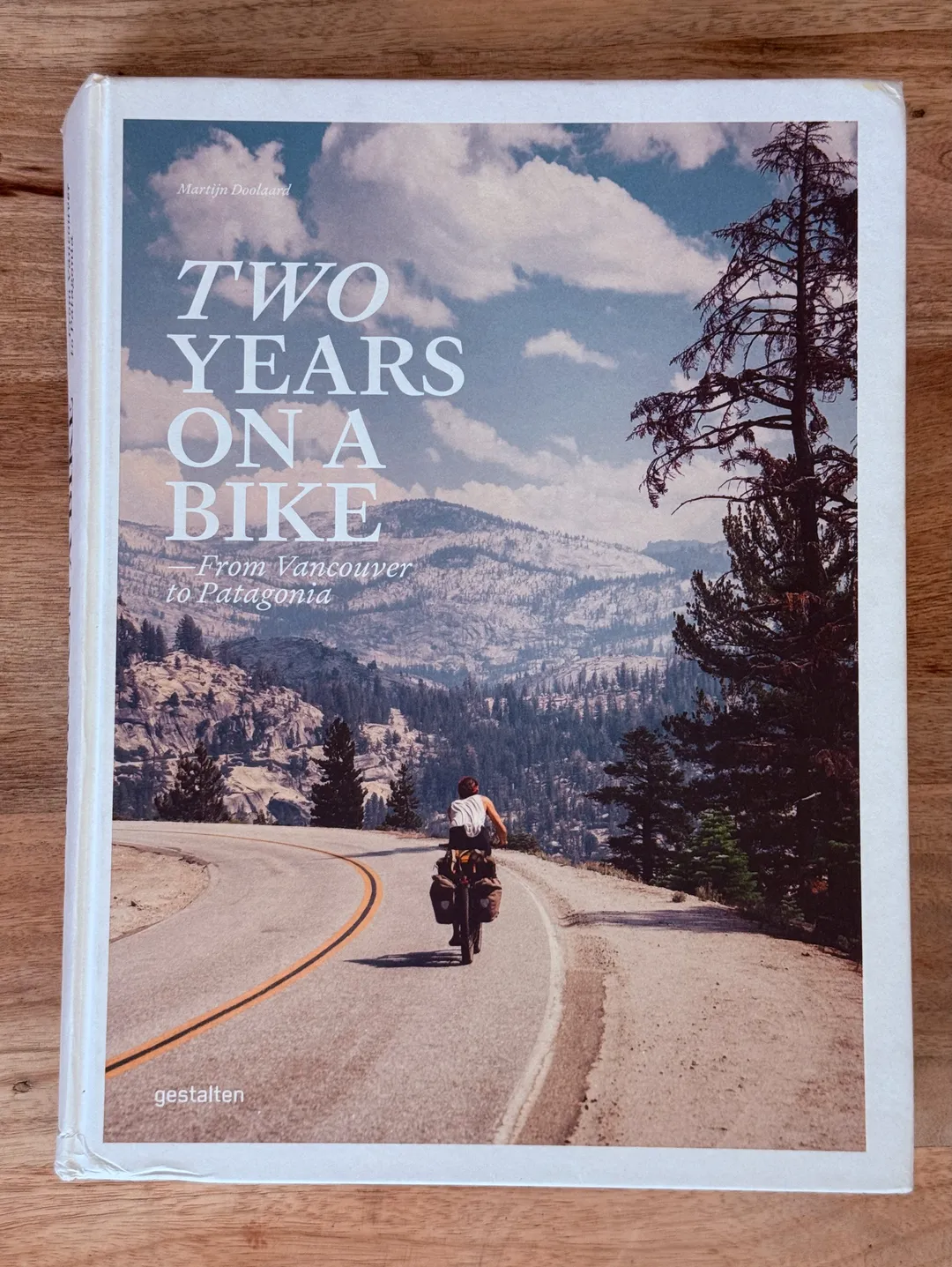 Two Years on a Bike: From Vancouver to Patagonia, cover of a cyclist on a mountain road