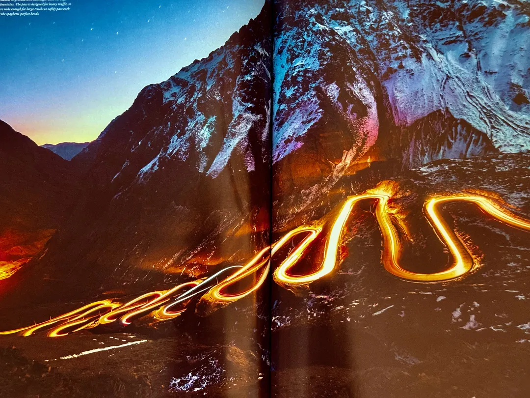 Light trails of a bike headlamp on switchbacks under a starry sky