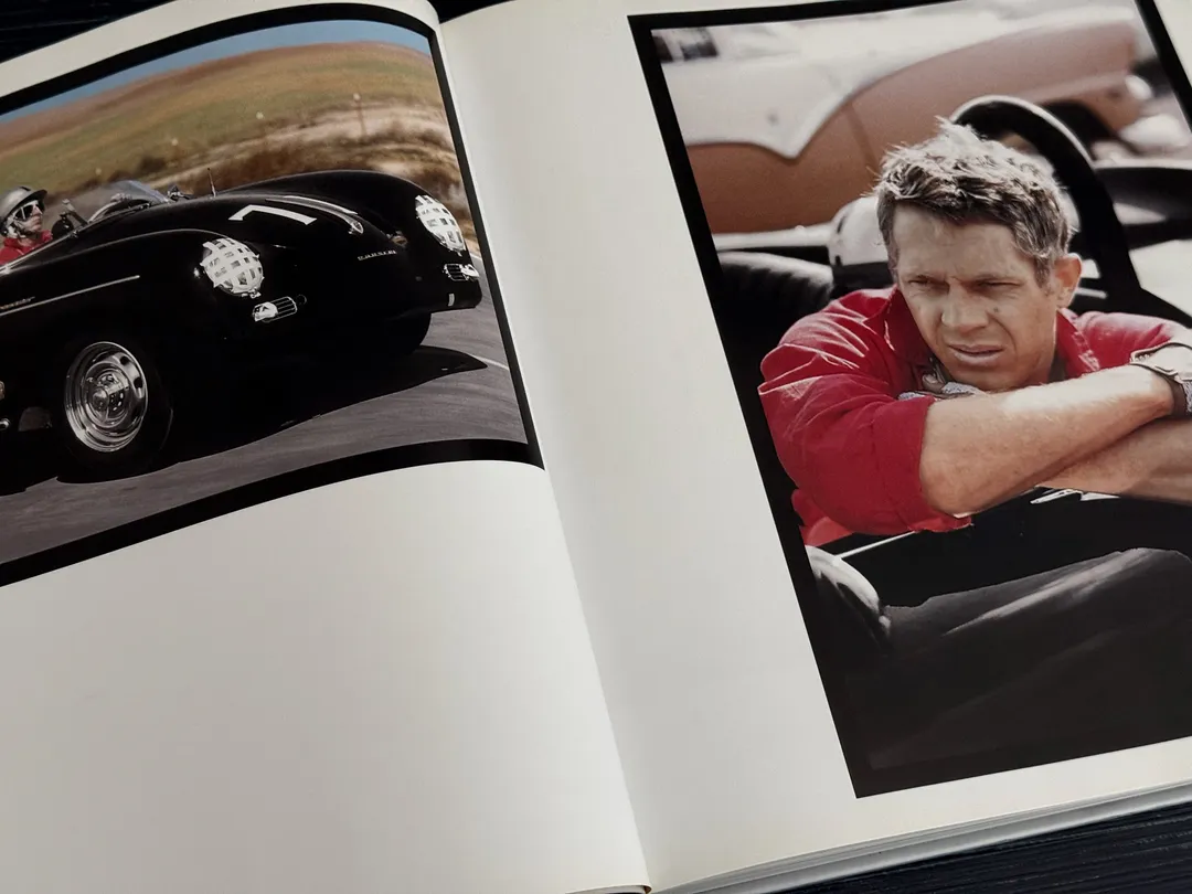 Vintage sports car, and McQueen in a red shirt at the wheel